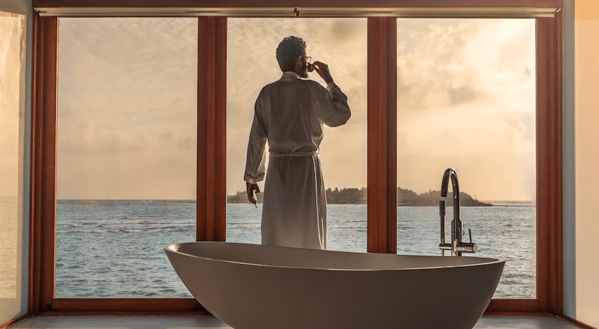 person enjoying the sea view from a Bathroom. Dream Drop Jackpot